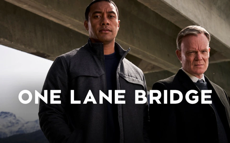 One lane bridge cover with two people standing under a bridge