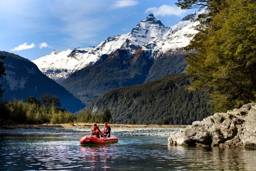 Couple on inflatable Kayak through alpine river 